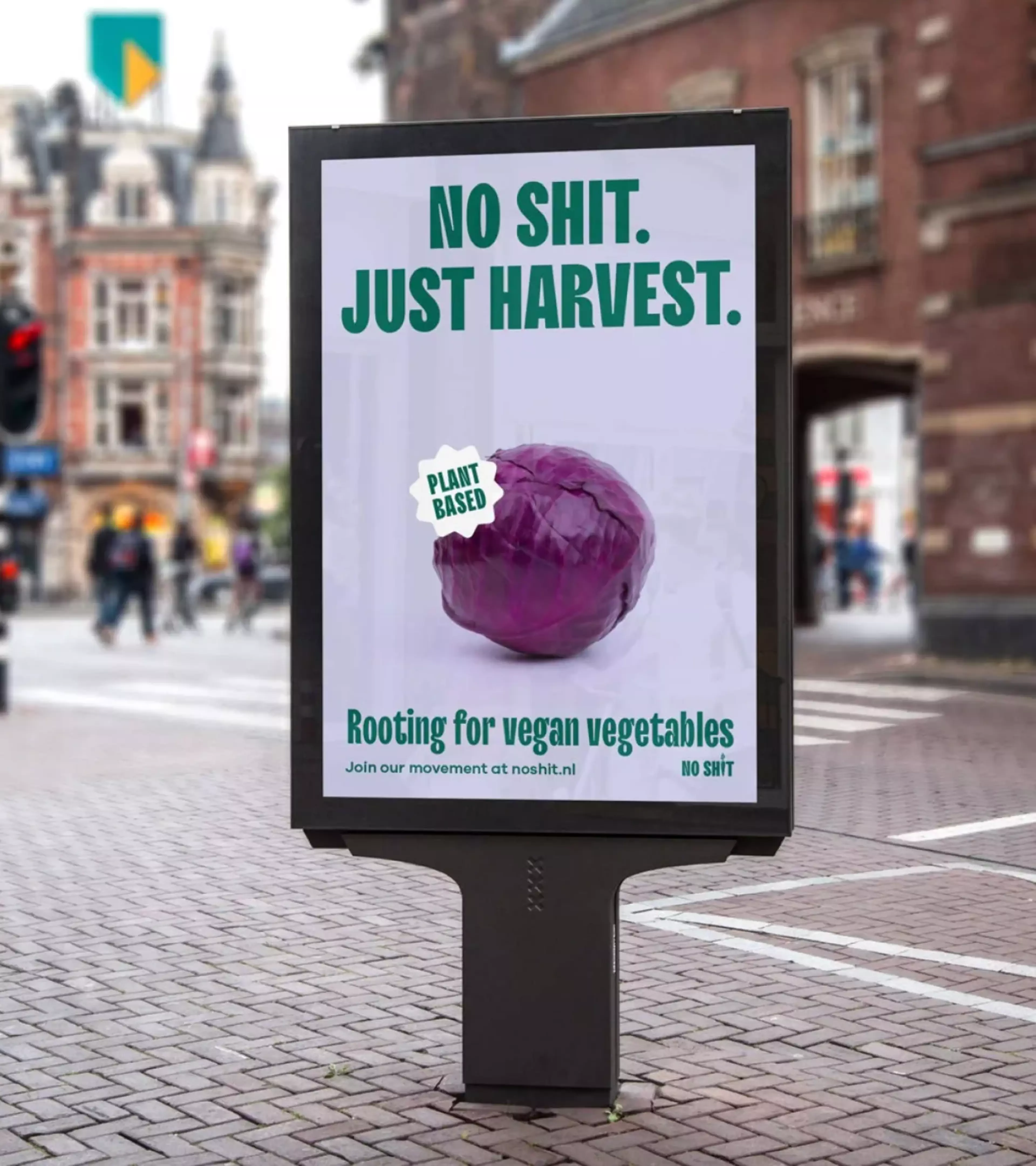 A single billboard in the middle of the city featuring the design of a red cabbage on a light purple background