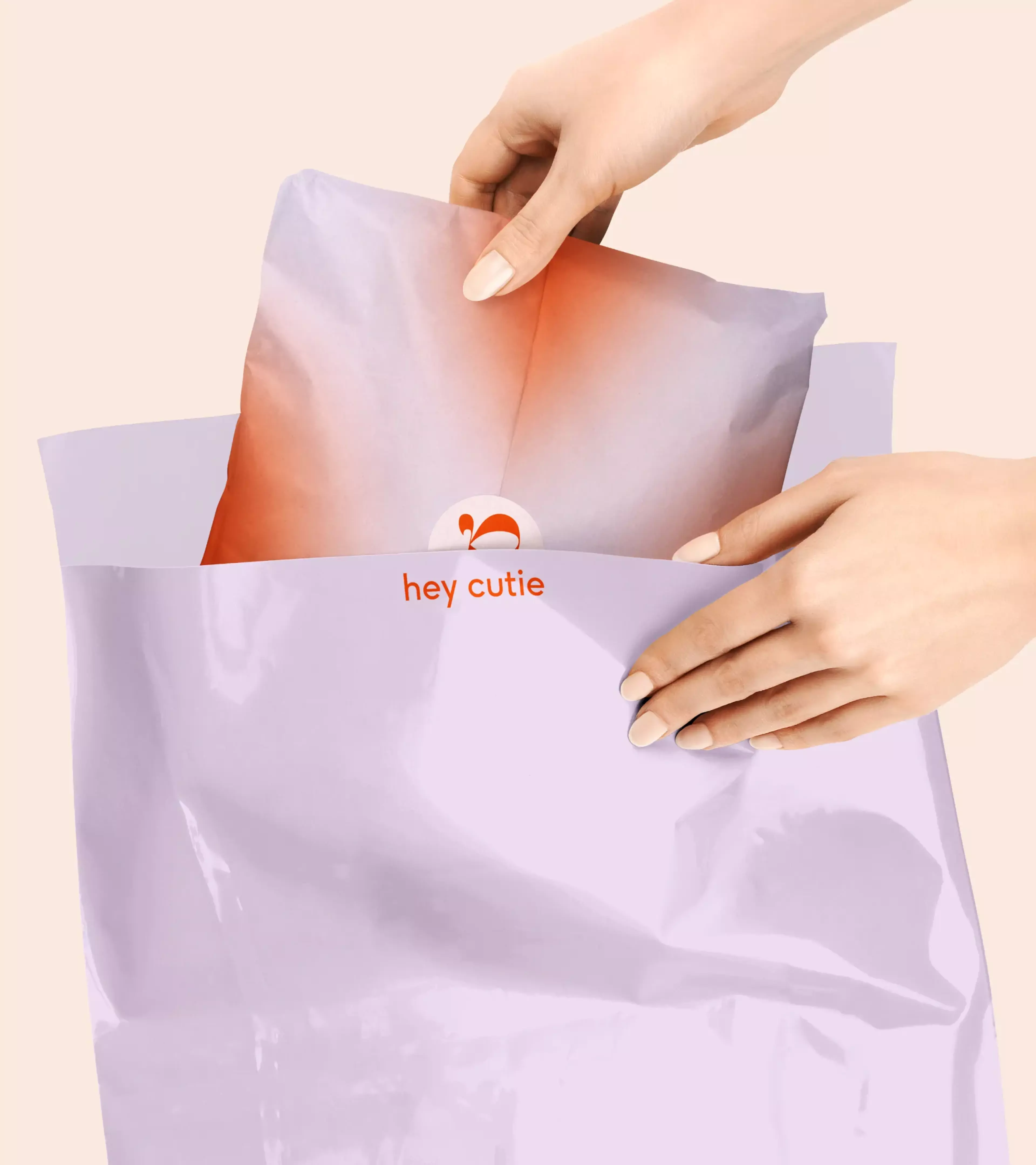 An image of a hand sliding a paper bag into a package