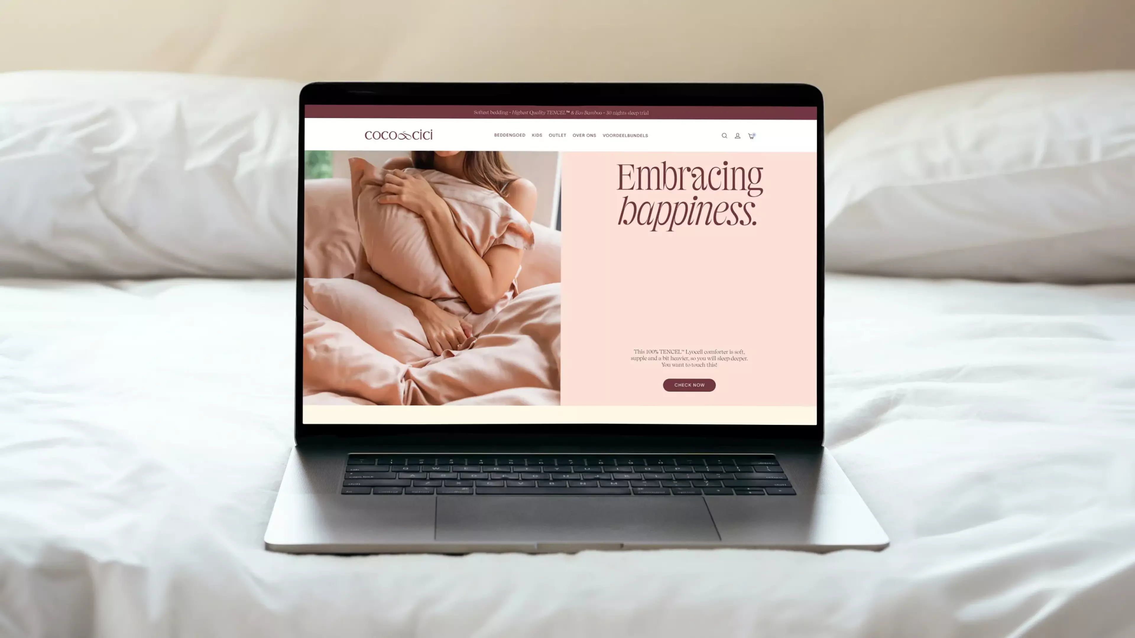 Picture of a laptop on a bed with the homepage of Coco & Cici